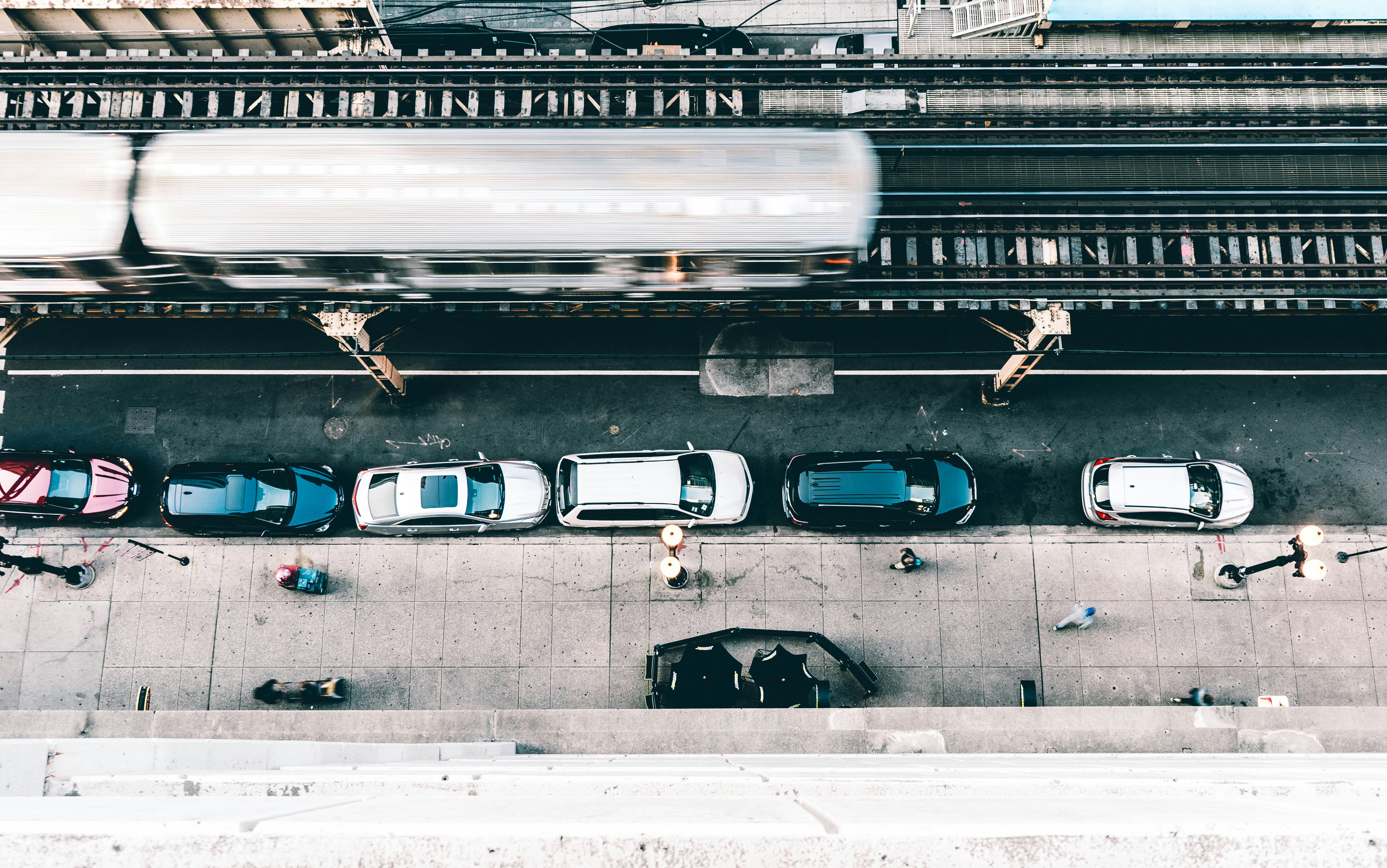 flat lay photography of cars parked beside building